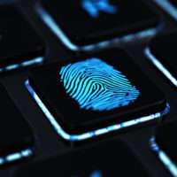 Computer keyboard button with blue fingerprint